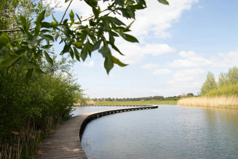 a body of water next to a wooden walkway