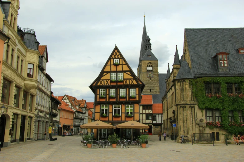 buildings, tables and benches lining the side walk