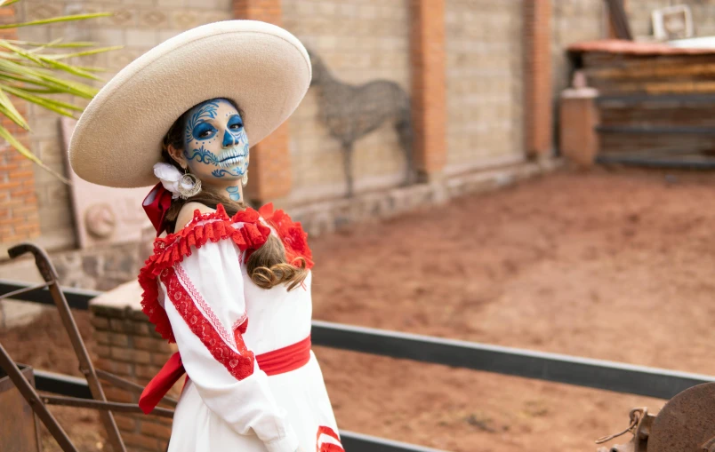 a man with blue makeup and a skeleton mask