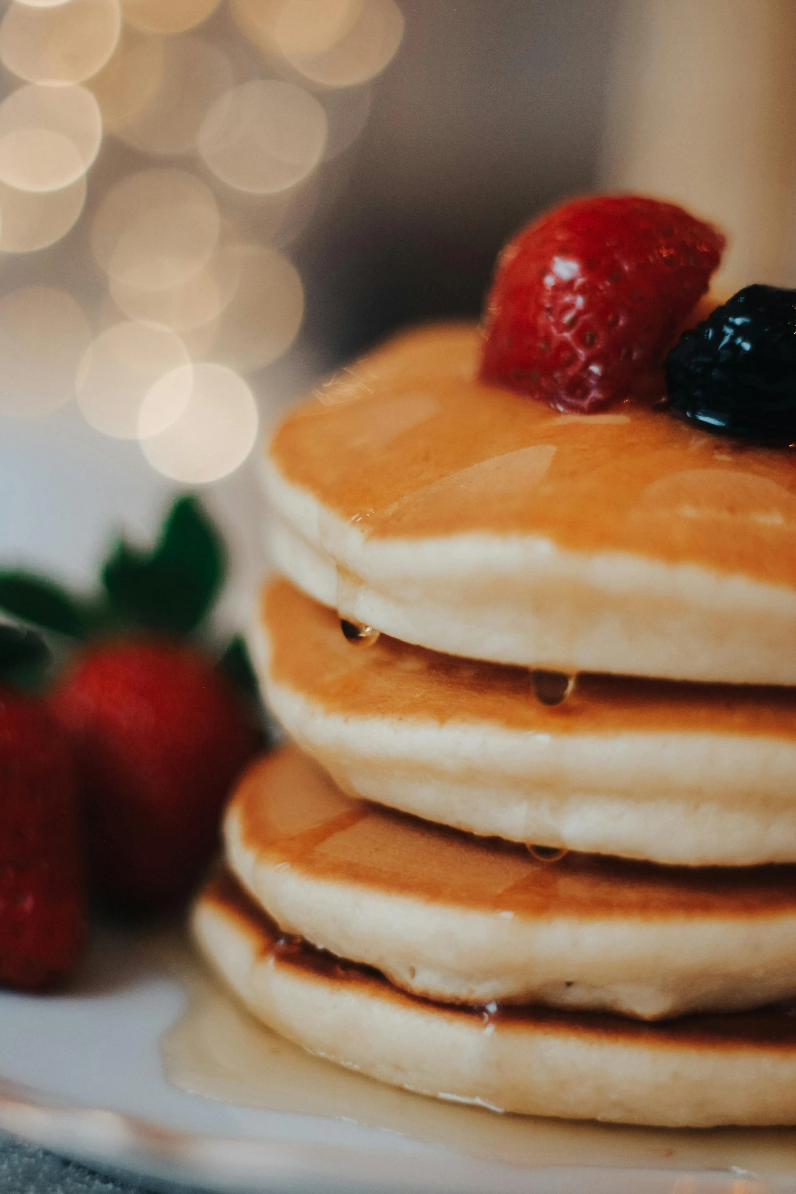 some pancakes that have some strawberries on top