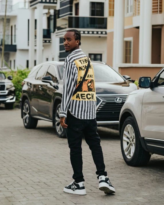 a young man standing in the middle of a street