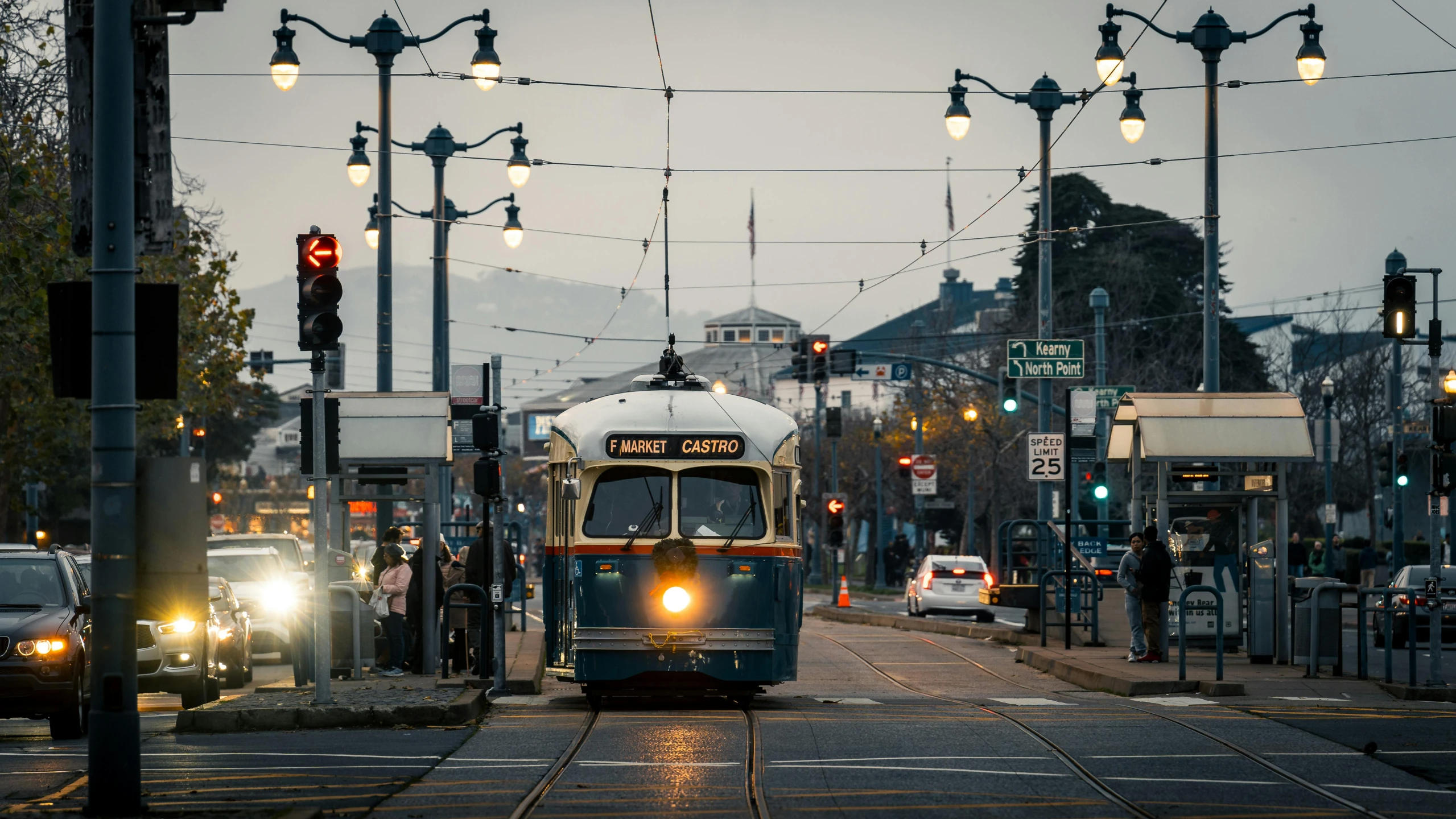 a light rail trolley driving down the street