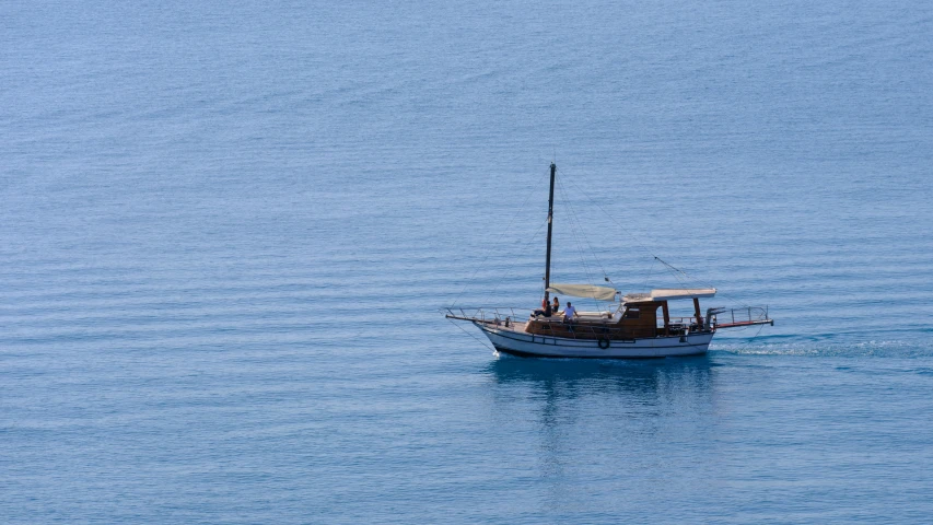 the small fishing boat is speeding across the water