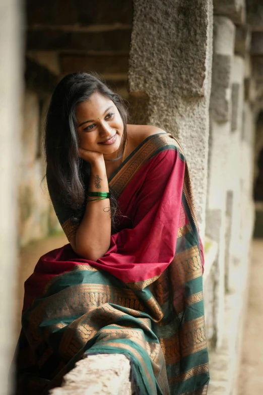 the woman in the traditional indian sari is posing for a picture