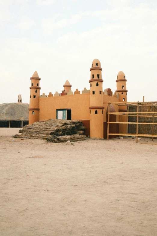 the house is made of clay and has many windows