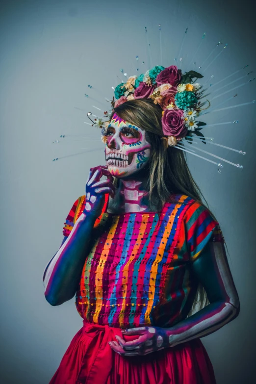 a woman in a striped shirt and colorful makeup