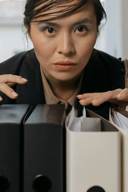 a woman with a large pair of scissors on her finger