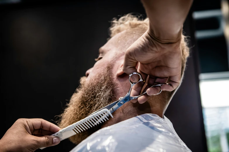 a man is brushing his hair with a razor