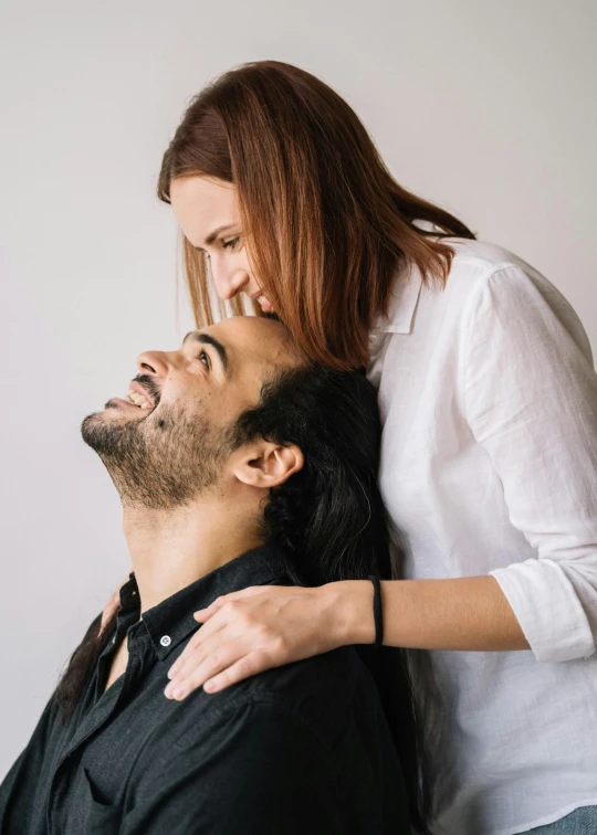 a man has his neck wrapped around a woman