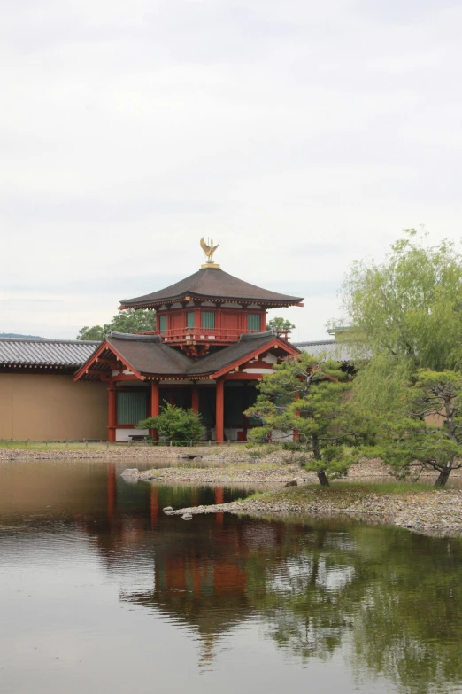 a beautiful and tranquil japanese home with pond in the foreground