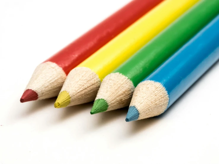 colored pencils lined up in a row on white