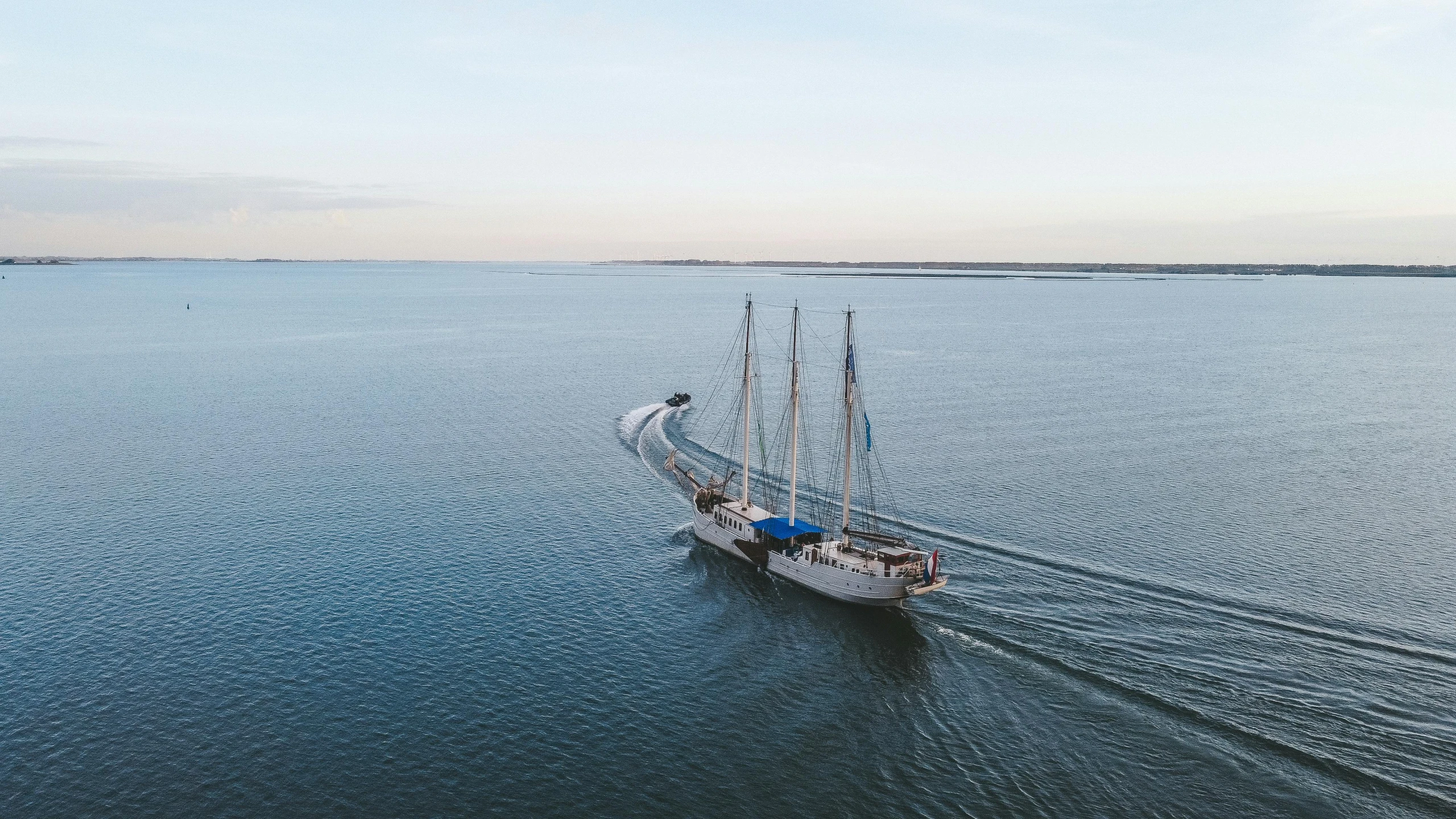 an aerial view of a boat moving through the water