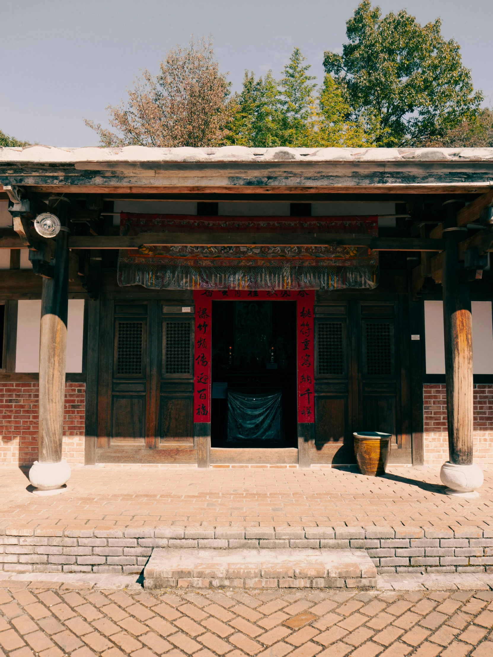 a building with red and black doors and columns