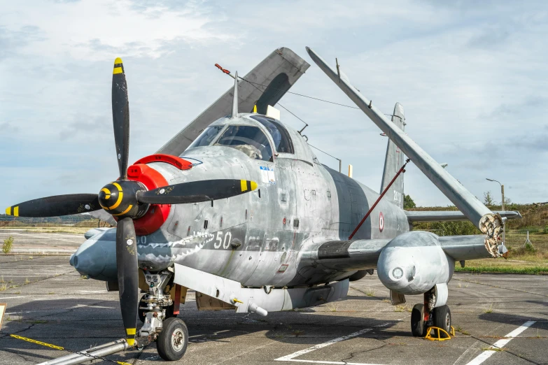 a fighter jet sits parked next to another aircraft