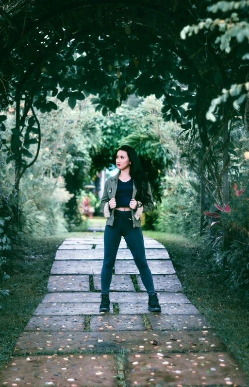 a beautiful woman posing on a brick walkway