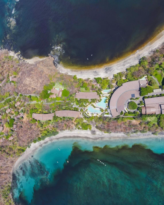 an aerial view of a residential area and a body of water