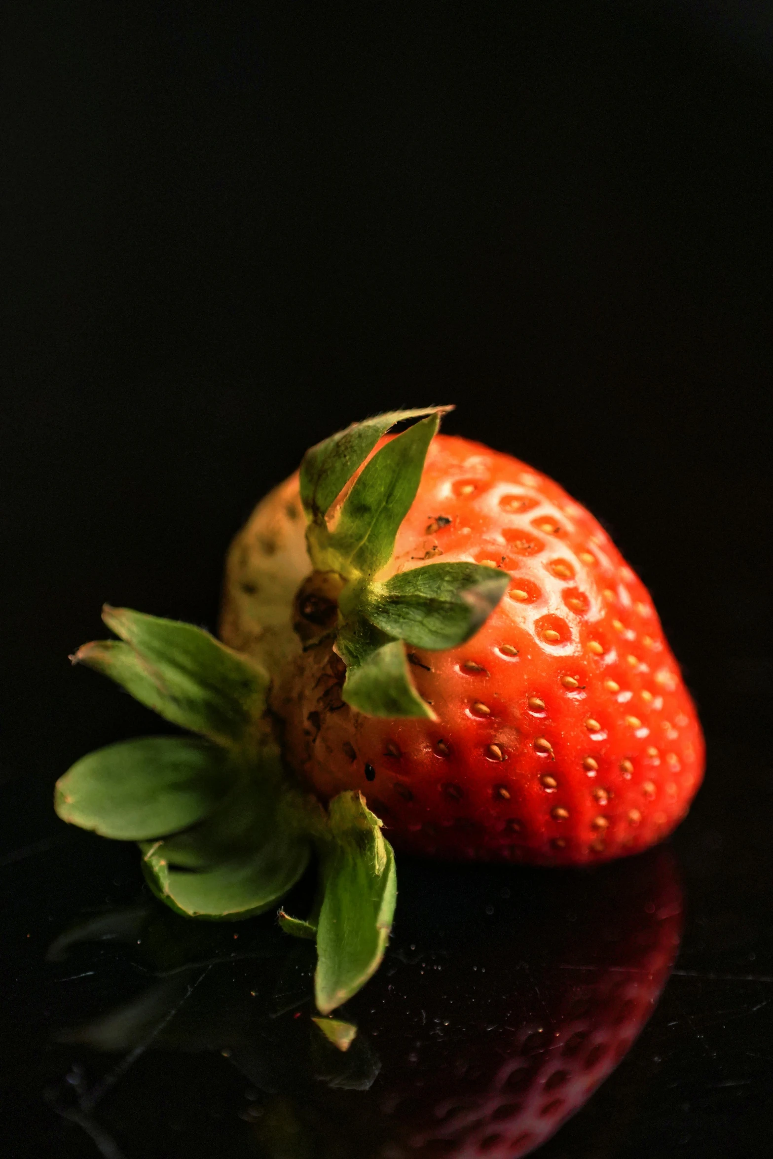 the lone strawberry has a green stem