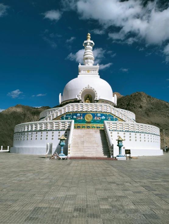 a big white building sitting on top of a stone floor