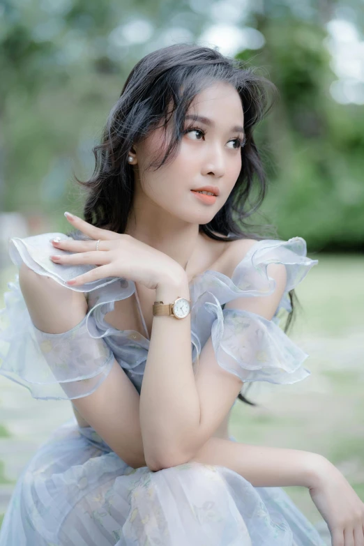 a young woman wearing an elegant dress and posing