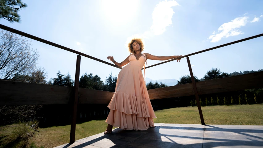 a woman is standing at the railing and posing for the camera