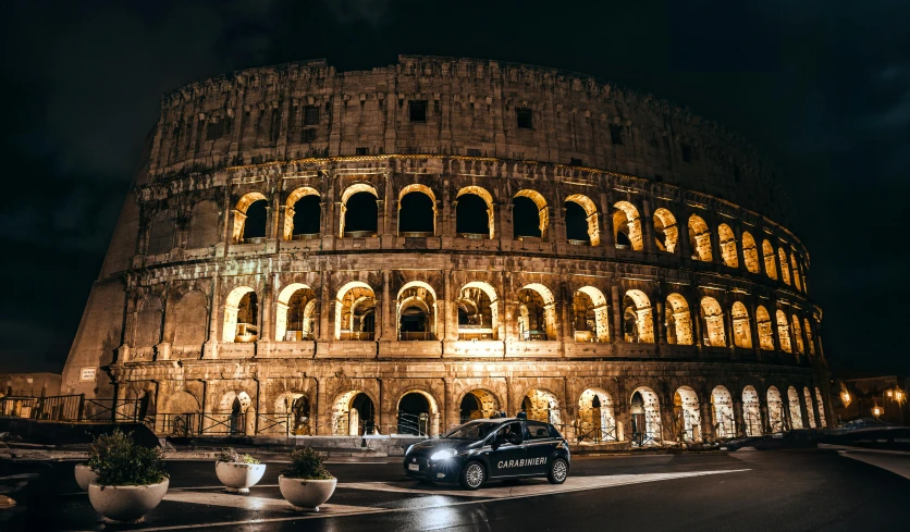 a large building with arches and lights in front of it