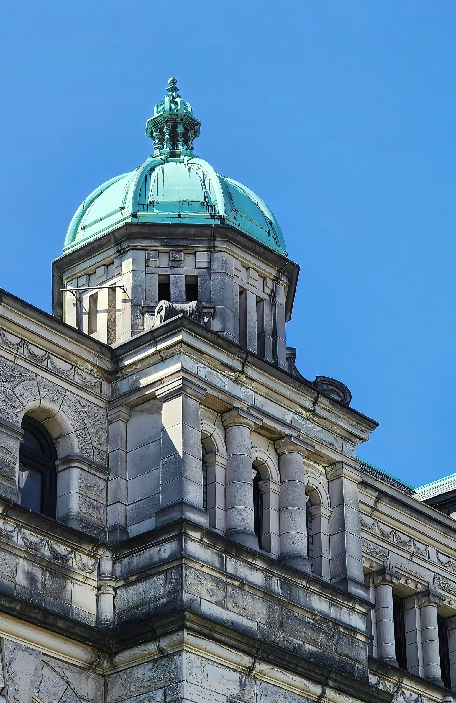 a very tall church tower with a copper top