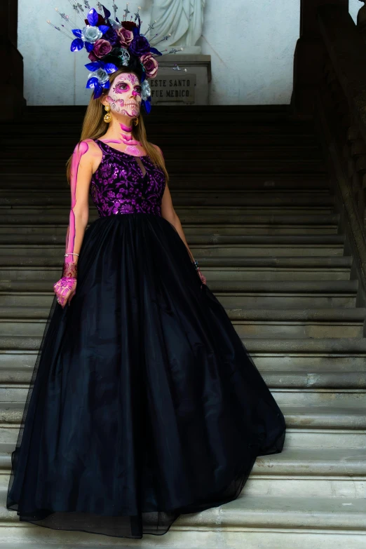 the girl wears a pink mask and black gown