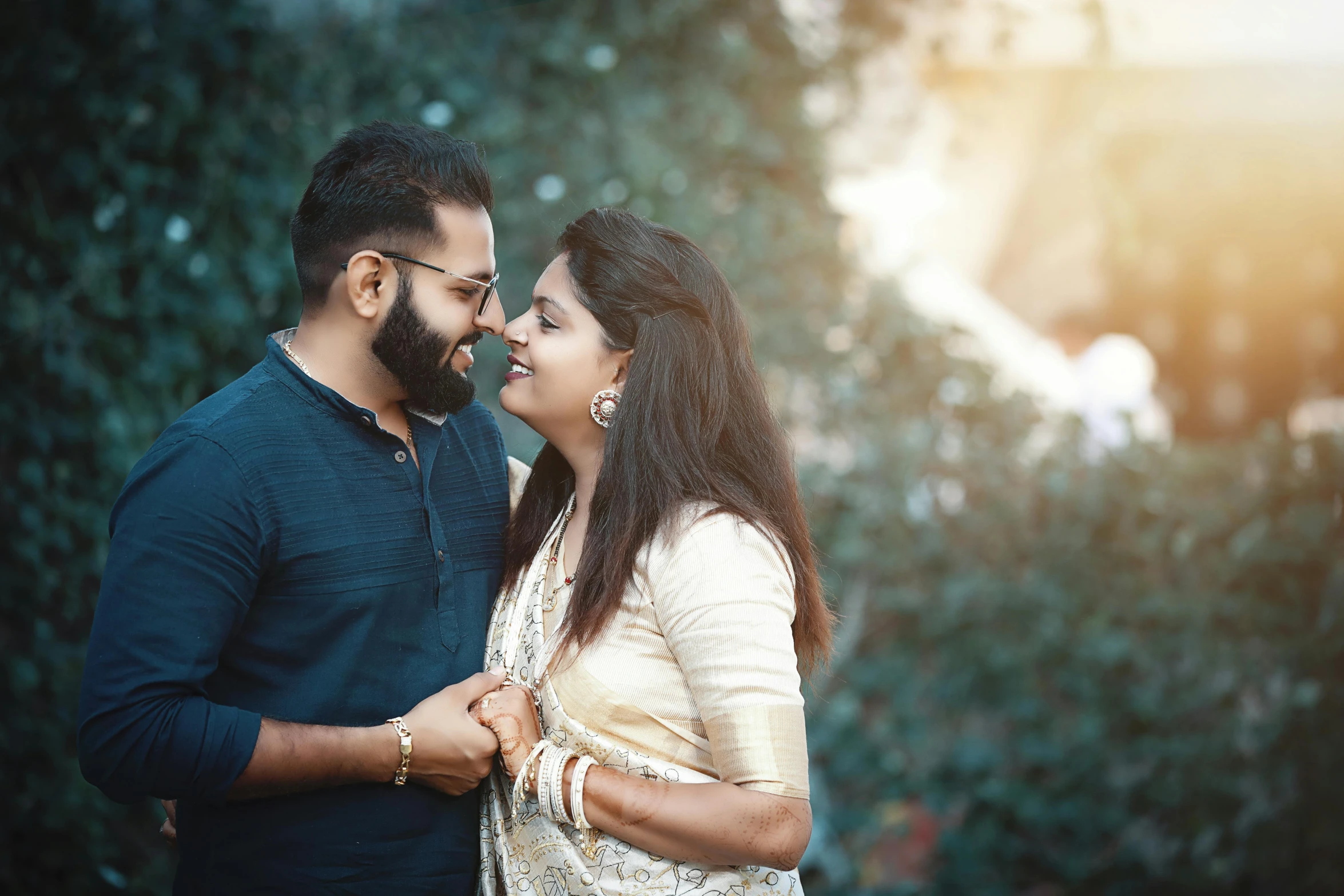 the man is giving his wife a kiss on the forehead