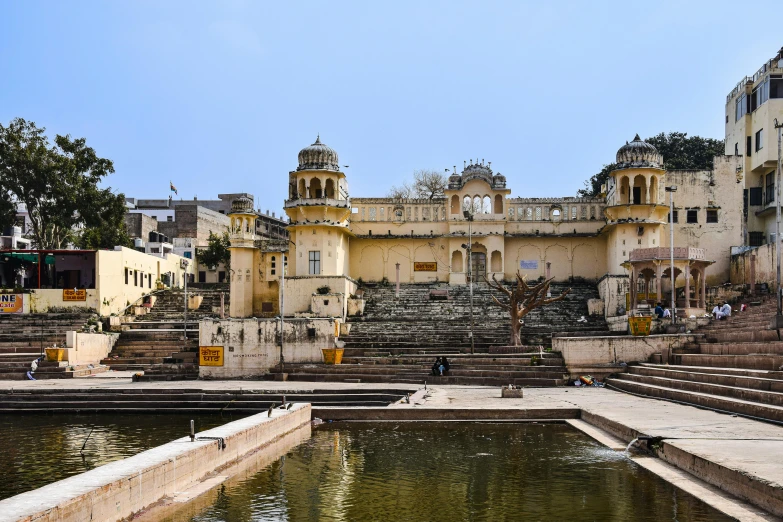 a lake sits in front of a large building