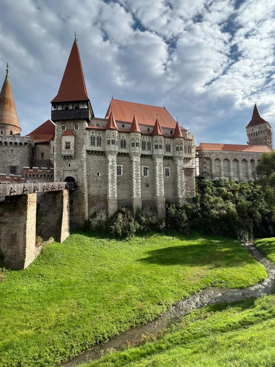 a castle built into the side of a grassy hill