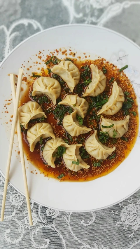 dumplings with sauce are sitting on a plate