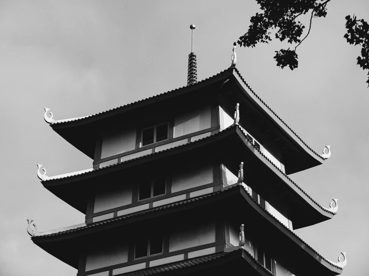 a tall tower sitting under a cloudy sky