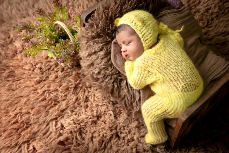 a newborn baby sleeping on a sheep fur covered blanket