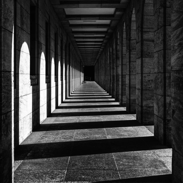 an empty building with lots of windows and stone floor