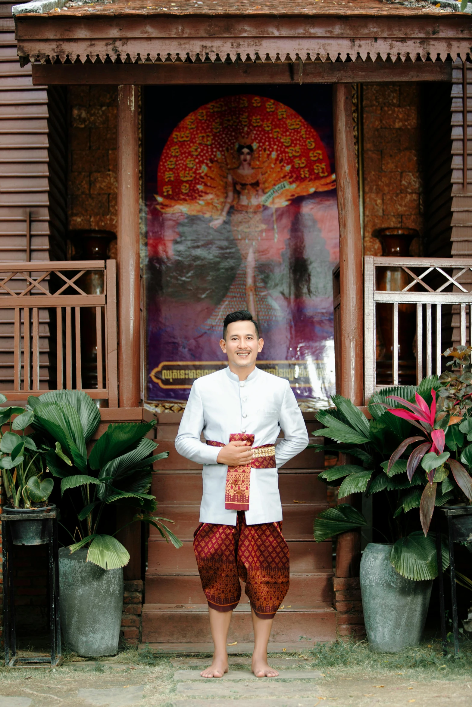 a man is posing in front of a decorated house