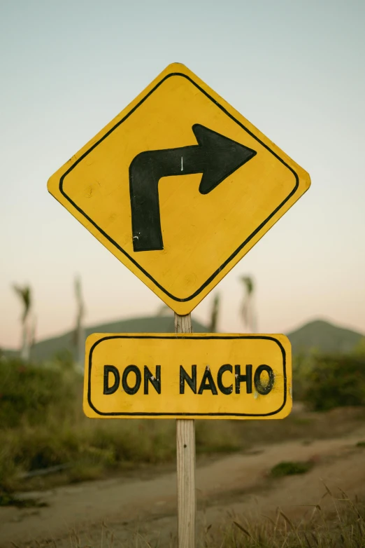 two street signs in a yellow sign that reads don nacho