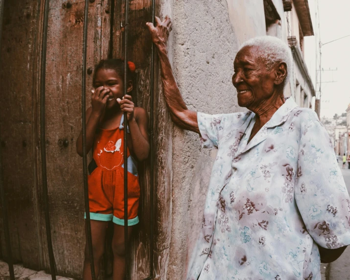 an older woman is standing in front of a  with a baseball bat