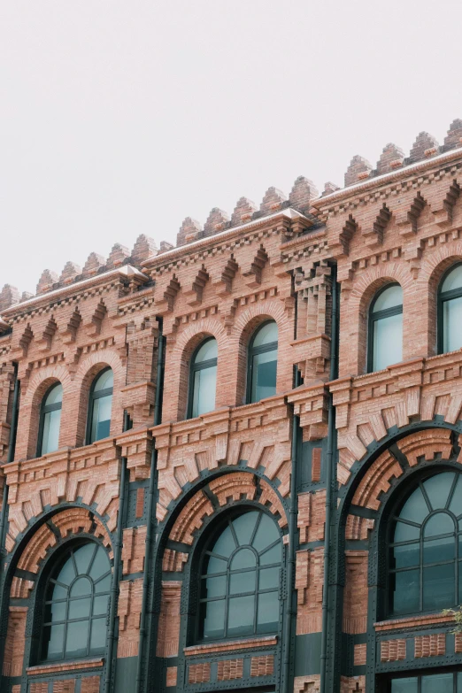 this brick building has arched and cylindrical windows