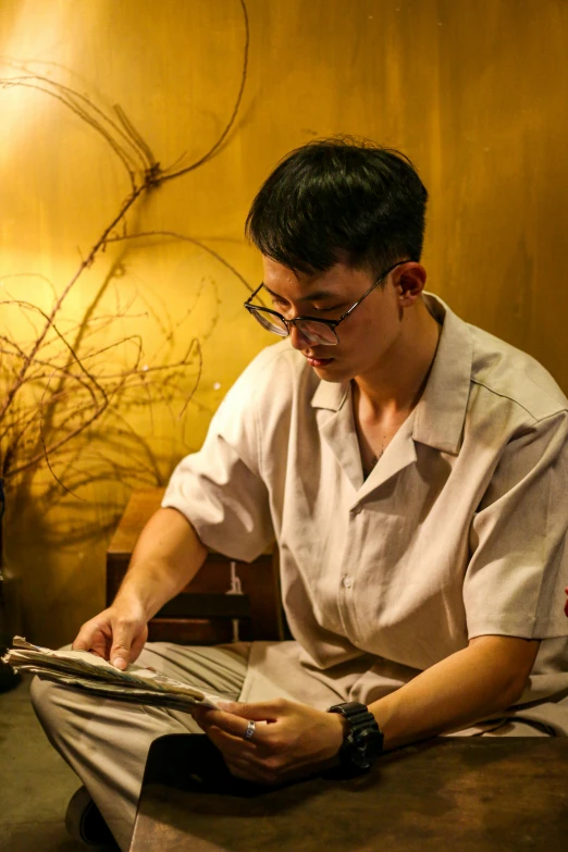 a man in a shirt looking at soing on a table