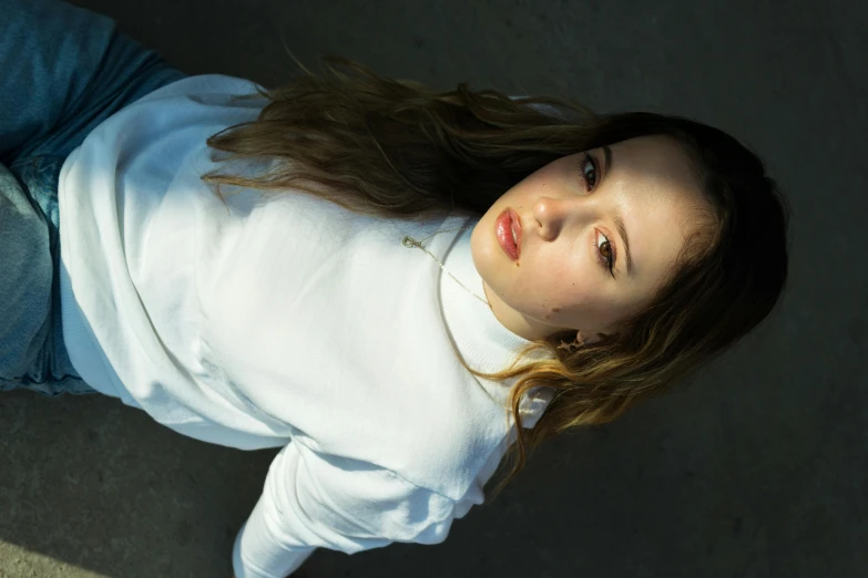 young beautiful woman laying on the ground looking up at soing