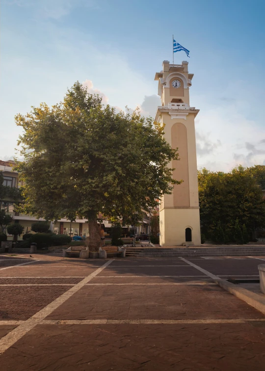 a white clock tower and some steps near it