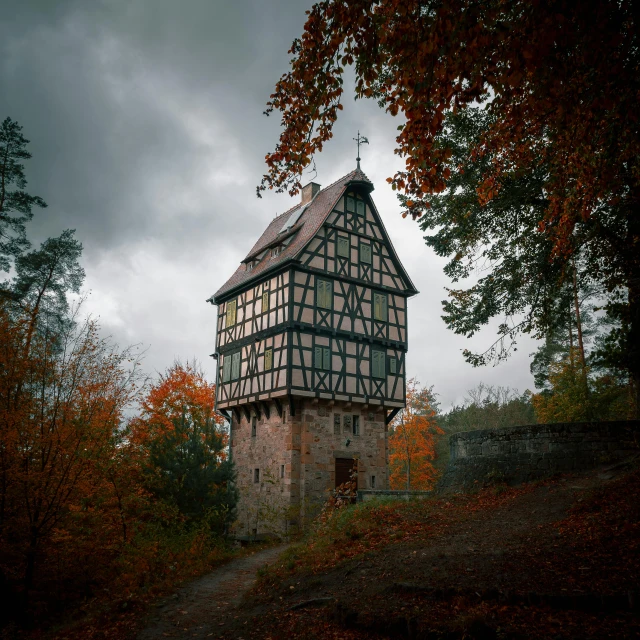 a building sitting near some trees with leaves around it