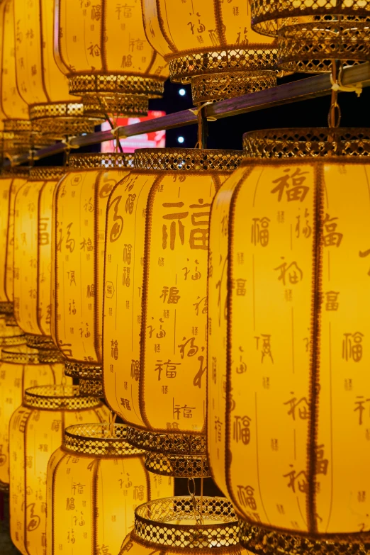 several rows and rows of yellow lamps with asian writing