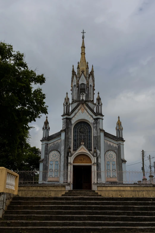 a small cathedral with a steeple and windows on it