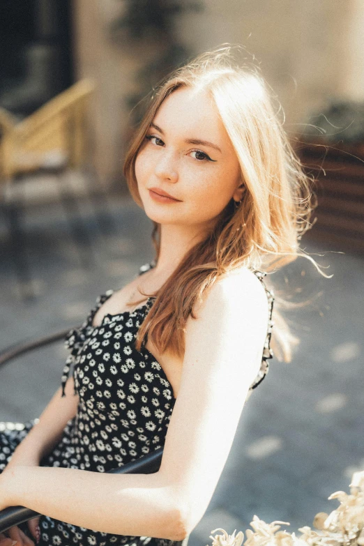 a woman with her hands on her hips sitting on a bench