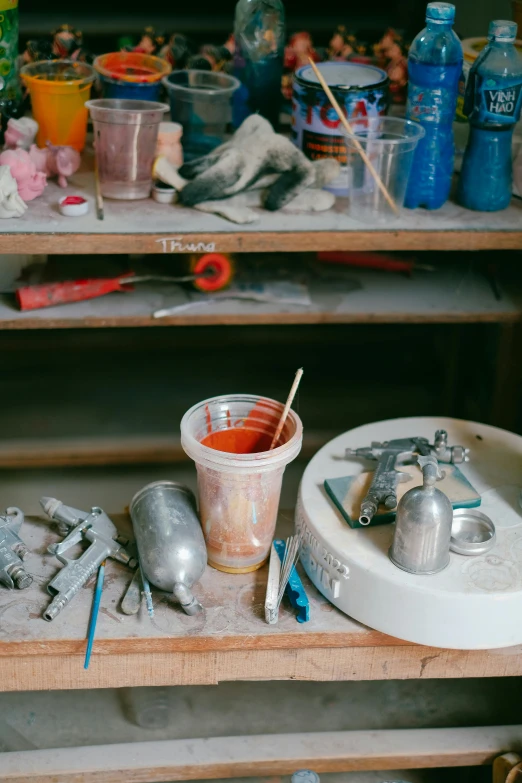 the messy desk has tools sitting on it