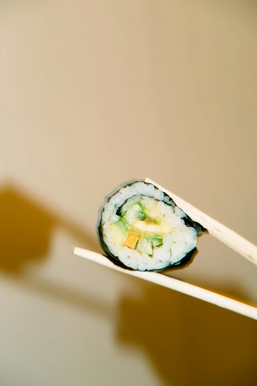 the sushi has been folded on chopsticks