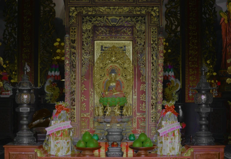 a large golden statue in a small room