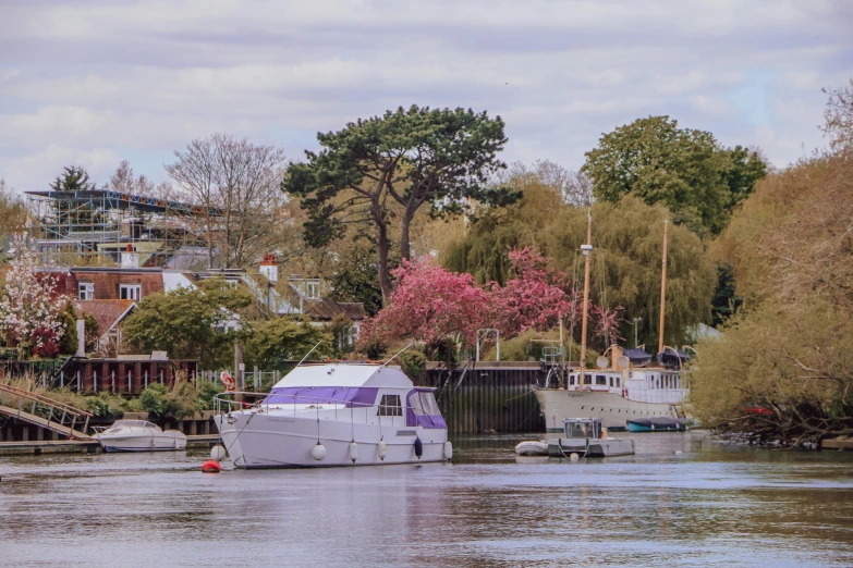 the boats are traveling down the river on a partly cloudy day