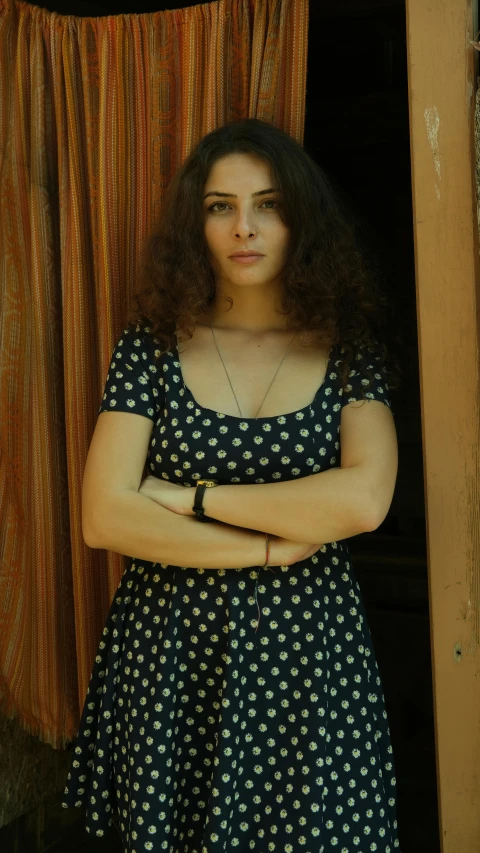 woman with long hair posing by a door